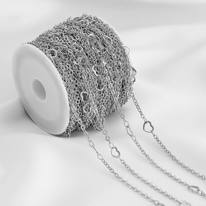 Macro detail of silver stainless steel heart-link chain on spool for DIY jewelry