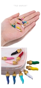 Macro shot of colorful enamel chili horn pendants for DIY jewelry and bracelets