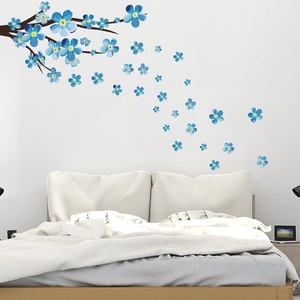Detail of blue plum blossom wall sticker on a white bedroom wall for home decor