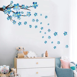 Detail of blue plum blossom wall sticker with branch on a clean white interior wall