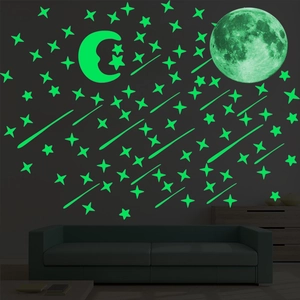 Luminous green moon and stars wall sticker set glowing in a dark bedroom setting