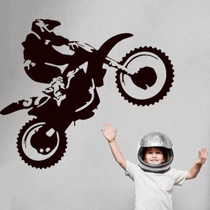 Detail of black vinyl motocross rider wall sticker in a teenager bedroom setting