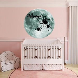 Halloween moon and spider wall stickers displayed in a cozy pink nursery room setting