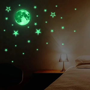 Luminous wall sticker set featuring a realistic moon and stars in a dark bedroom