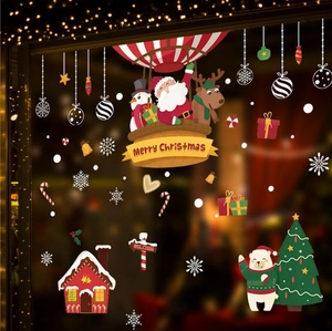 Christmas wall stickers featuring Santa Claus and reindeer on a festive glass window display