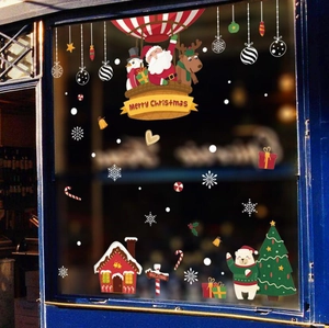 Detail of Christmas window stickers featuring Santa on a hot air balloon and snowmen