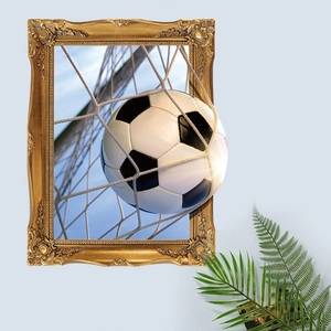 Detailed 3D soccer ball wall sticker bursting from a vintage gold frame on a blue wall