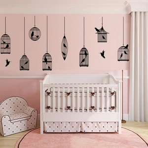 Detailed black silhouette birdcage wall stickers shown in a cozy pink nursery setting