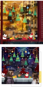 Detailed view of festive Christmas glass decals showing Santa and reindeer window stickers