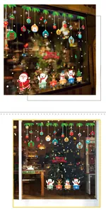 Detail showing cartoon Santa Claus and reindeer stickers on a glass window pane