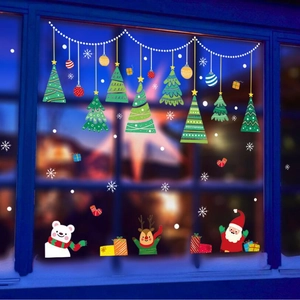 Detailed Christmas window stickers with Santa and reindeer on glass with festive lights