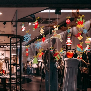 Christmas window decals with snowman and Santa patterns on a retail glass storefront