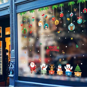 Detail of Christmas train window decals with Santa Claus, polar bear, and colorful snowflakes