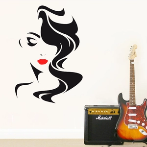 Detail of artistic vinyl wall decal featuring elegant woman face with red lips and long hair