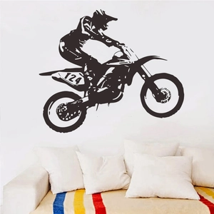 Black vinyl wall decal showing a motocross racer silhouette jumping over a sofa