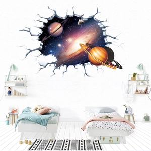 3D cracked wall effect sticker showing Saturn and galaxy in a kid bedroom setting