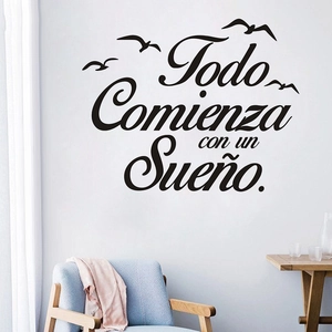 Detail view of Todo Comienza con un Sueño wall sticker with birds above a blue sofa
