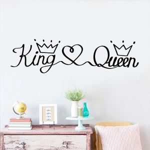Detail of King and Queen crown wall stickers on white wall above a wooden dresser