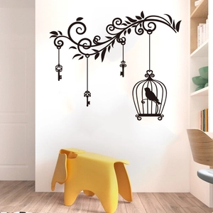 Detail of black birdcage and vine wall sticker in a minimalist Nordic living room decor