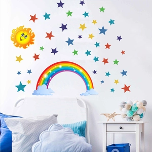 Detailed view of rainbow and star wall stickers in a cozy minimalist kids' bedroom decor