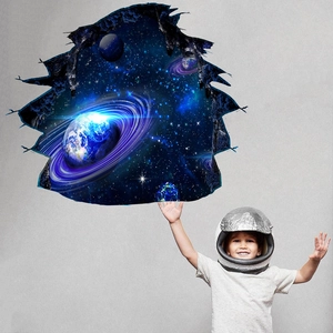 3D cracked wall decal showing space planet nebula with a boy reaching for the universe