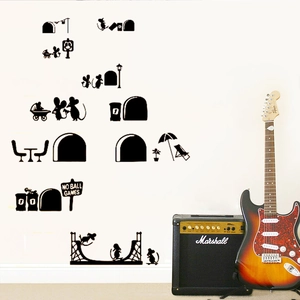 Detailed view of black cartoon mouse silhouette wall stickers on a clean white wall surface