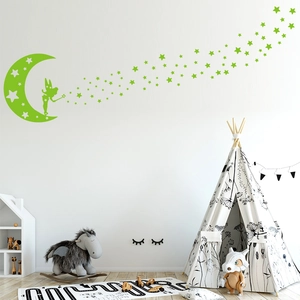 Luminous fairy and moon wall stickers glowing in a cozy nursery room setting