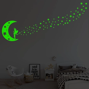 Luminous wall stickers featuring fairy and stars glowing in a dark children's bedroom