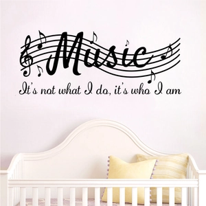 Detail of music notes vinyl wall decal with inspirational quote in a cozy nursery room