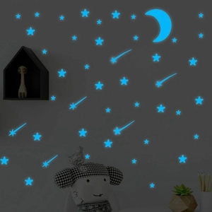 Luminous blue moon and stars wall decals glowing in a dark themed kids bedroom