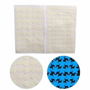 Detailed comparison of glowing star and moon wall decals in daylight and blue night glow