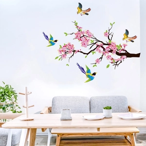 Detail of floral wall decals featuring colorful birds and plum blossoms in a living room
