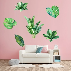 Tropical green monstera and palm leaf wall stickers in a modern pink living room decor