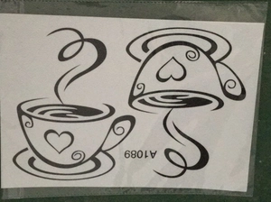 Detail of coffee cup temporary tattoo stickers with heart designs in clear packaging