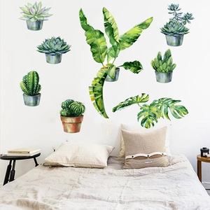 Detail view of watercolor tropical plant wall stickers applied on bedroom wall background