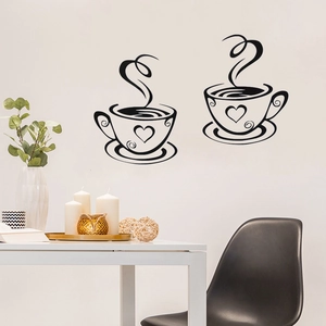 Detail of two minimalist black coffee cup wall stickers in a cozy kitchen setting