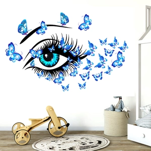 Detail of blue butterfly and eye wall decal in a modern minimalist bedroom setting