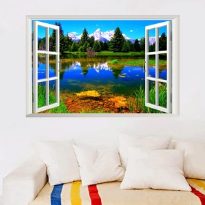 3D faux window wall sticker showing snowy mountains and lake scenery above a white sofa
