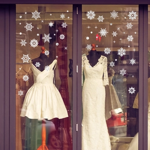 Elegant white snowflake window stickers for Christmas glass decoration in festive shops
