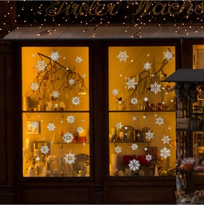Snowflake Christmas window stickers with festive glitter for glass shopfront decoration