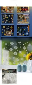 Detail of silk-screened gold and silver snowflake window stickers with glitter texture
