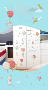 Detailed view of cartoon bunny with balloons wall stickers on a white nursery wardrobe