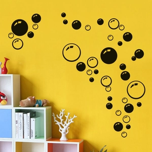 Colorful bubble wall decal stickers with circles on a bright yellow wall for home decor
