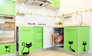 Detail view of modern black cartoon cat silhouettes applied to a kitchen cabinet surface