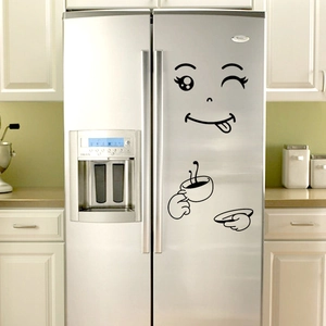 Detailed close-up of funny winking face fridge sticker on a modern silver refrigerator