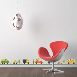 Detailed close-up of cartoon construction vehicle wall stickers used as a room baseboard