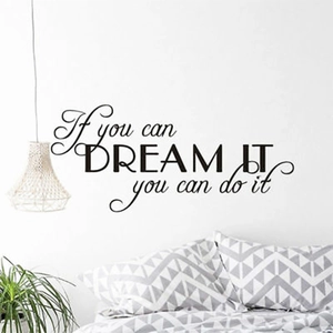 Close-up of Dream It Do It black vinyl wall sticker on a minimalist bedroom wall