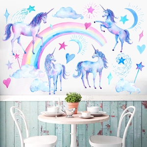 Watercolour unicorn wall stickers with rainbows and stars in a modern nursery setting