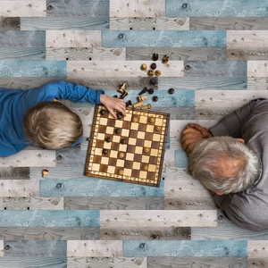 Classic wooden chess set with foldable board and pieces on a rustic wooden floor background