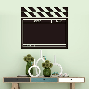 Creative movie clapperboard wall sticker on a green wall above a wooden cabinet